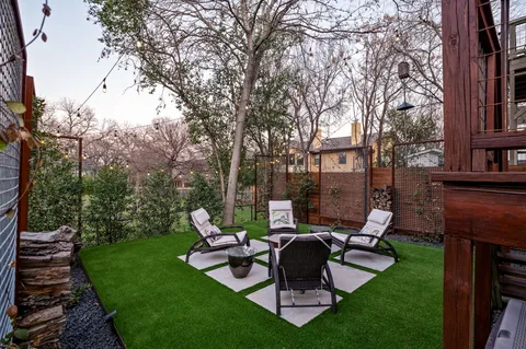 a view of a house with backyard porch and sitting area