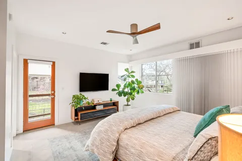 a bedroom with a bed and a potted plant