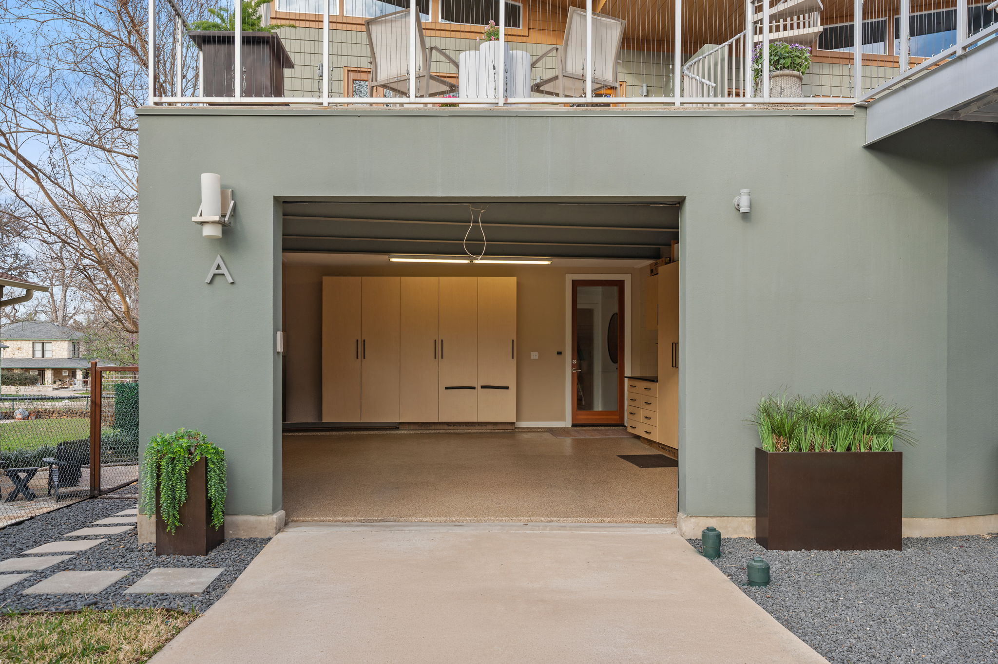 1700 Ravey Street, Unit A Austin, TX 78704 - Photo 34 of 40 Entrance to property with driveway, stucco siding, and an attached garage