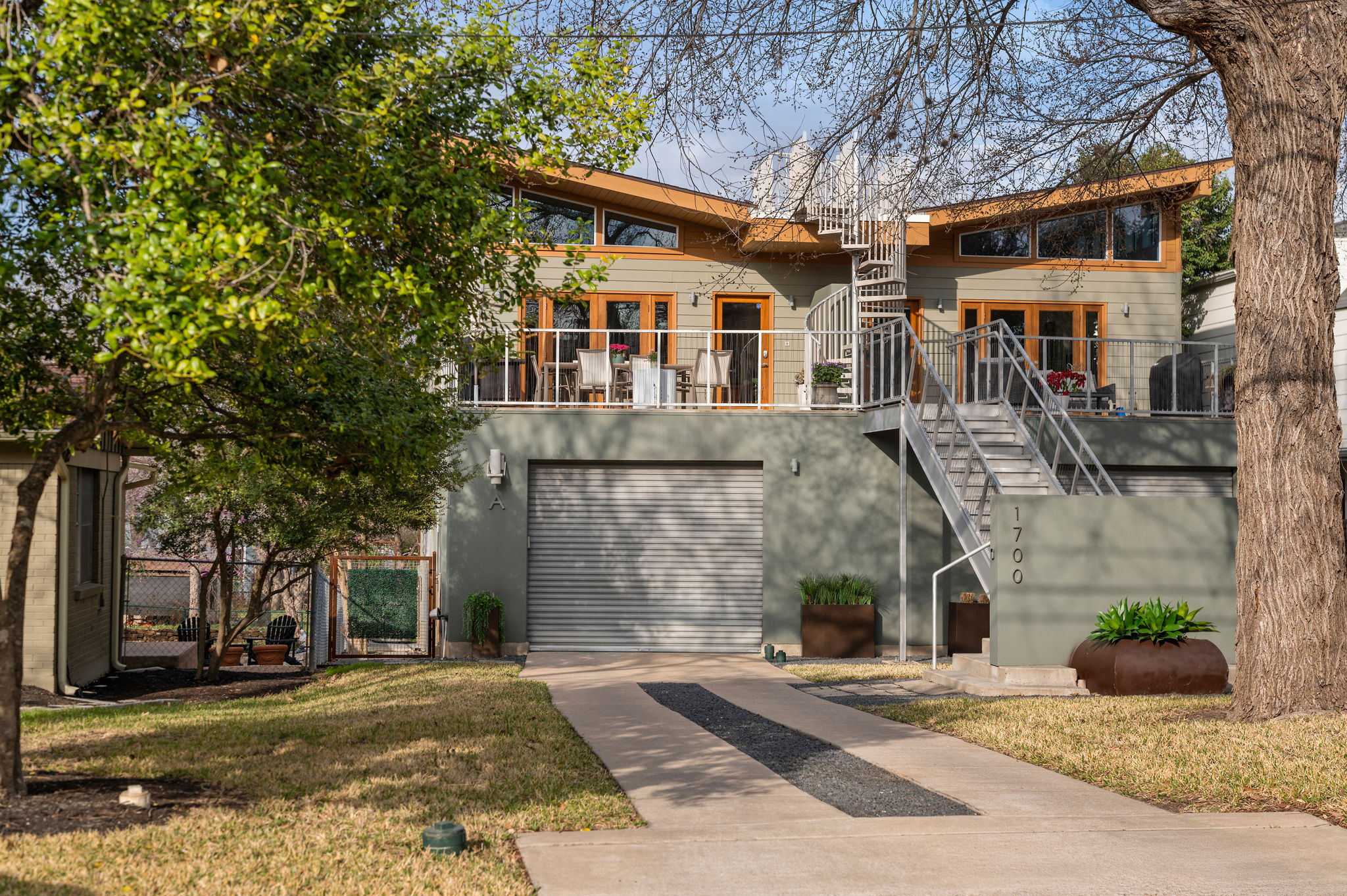 1700 Ravey Street, Unit A Austin, TX 78704 - Photo 36 of 40 View of front of home with concrete driveway, a garage, a balcony, and a gate