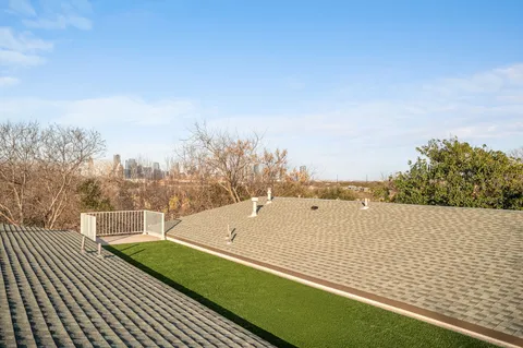 a view of a roof deck with furniture