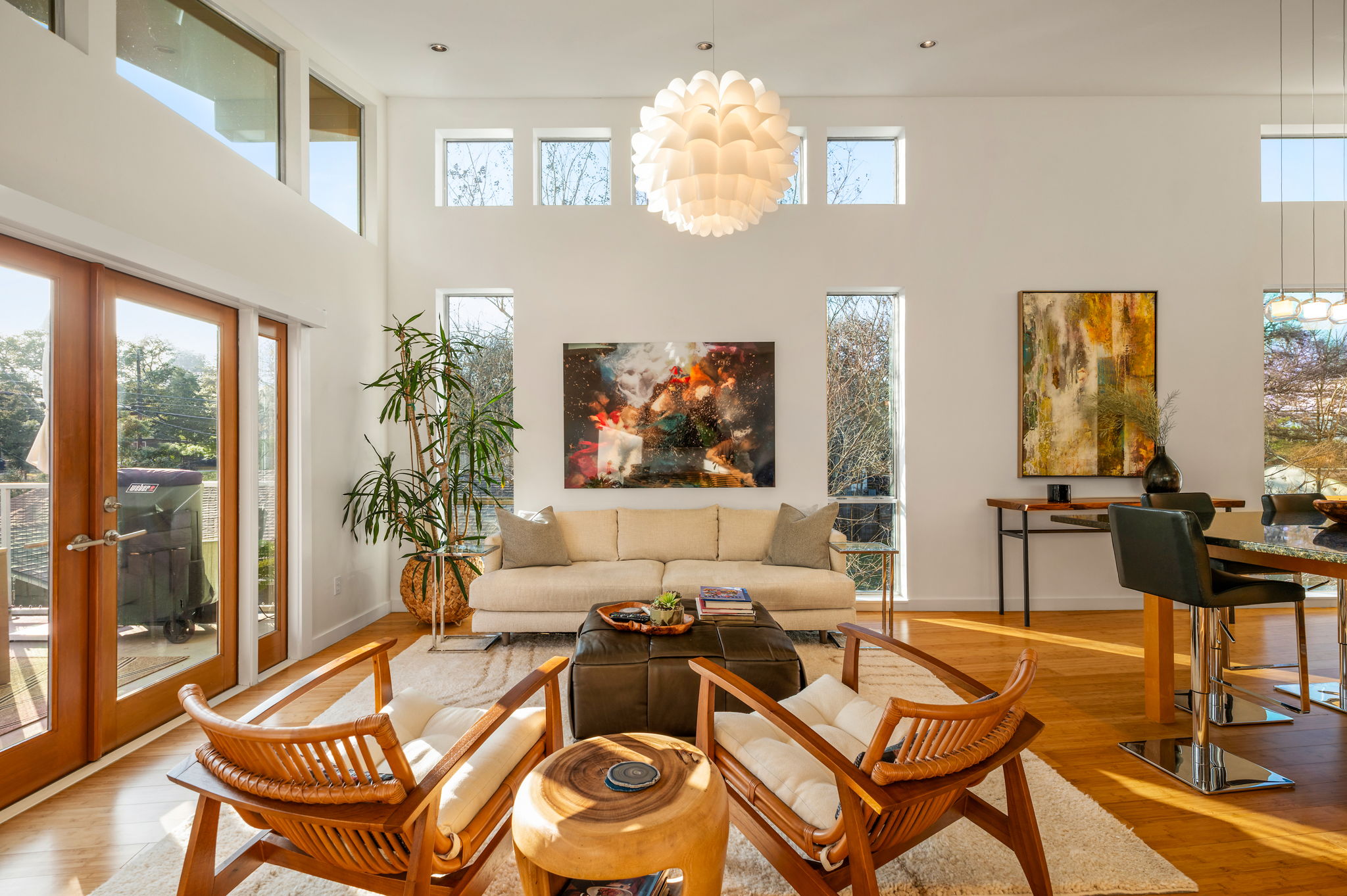 1700 Ravey Street, Unit A Austin, TX 78704 - Photo 5 of 40 Living area featuring french doors, wood-type flooring, a high ceiling, and a chandelier