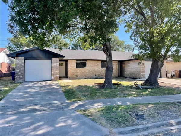 a house that has a tree in front of it