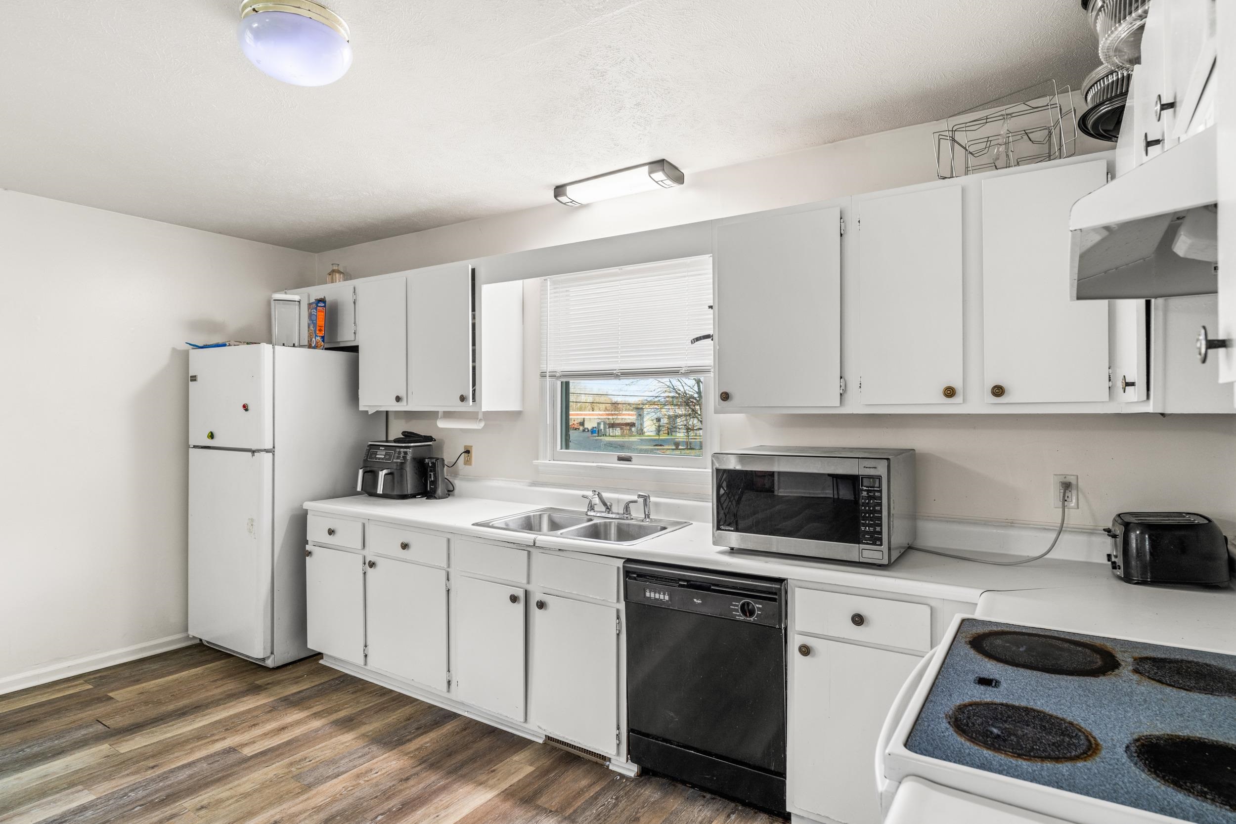 1316 East Main Street Waynesboro, VA 22980 - Photo 17 of 34 a kitchen with a sink a refrigerator and cabinets