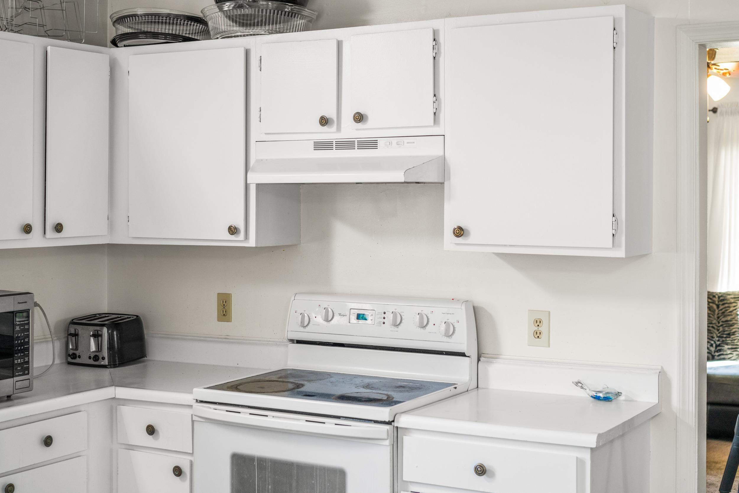 1316 East Main Street Waynesboro, VA 22980 - Photo 19 of 34 a kitchen with granite countertop white cabinets and white appliances