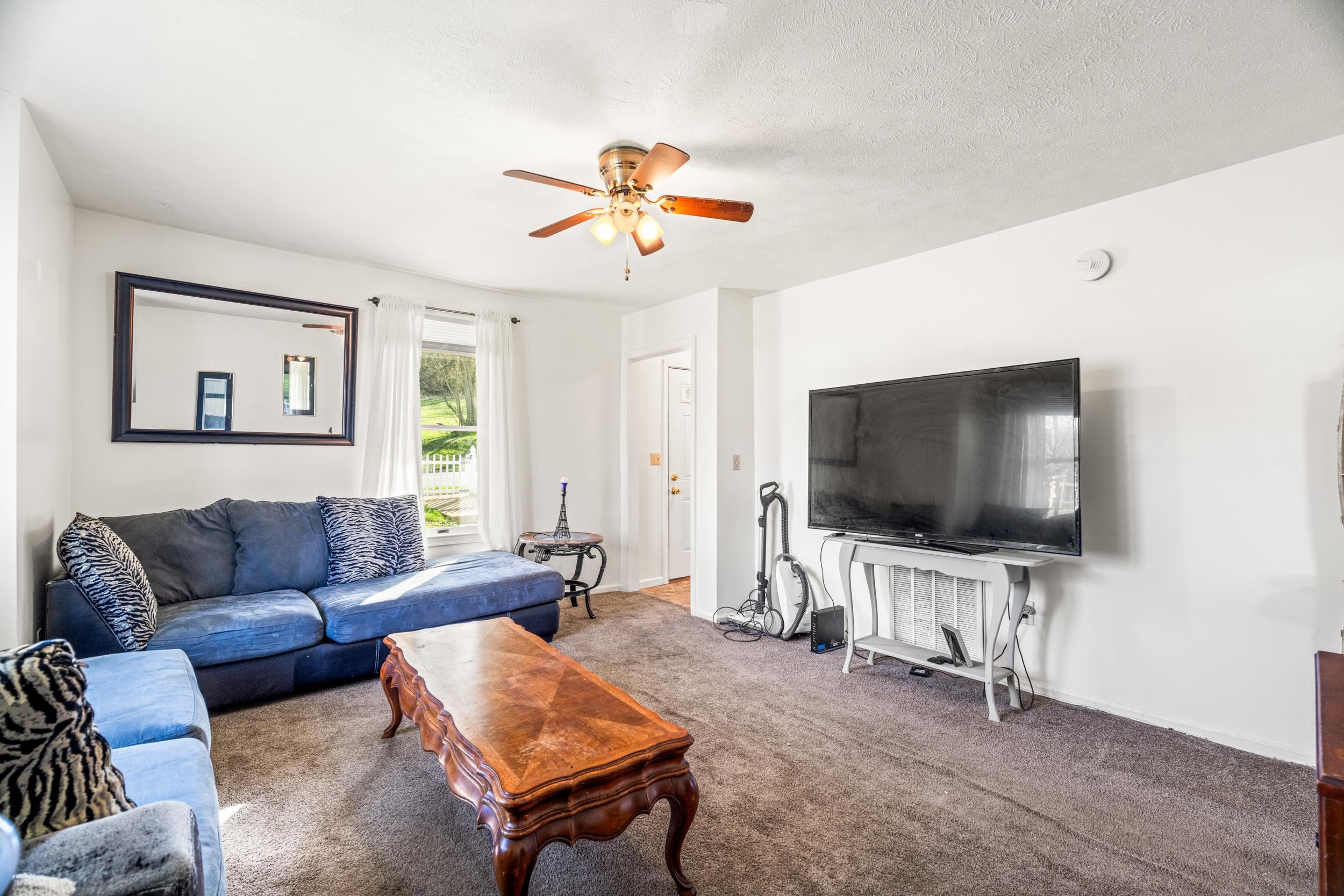 1316 East Main Street Waynesboro, VA 22980 - Photo 23 of 34 a living room with furniture and a flat screen tv