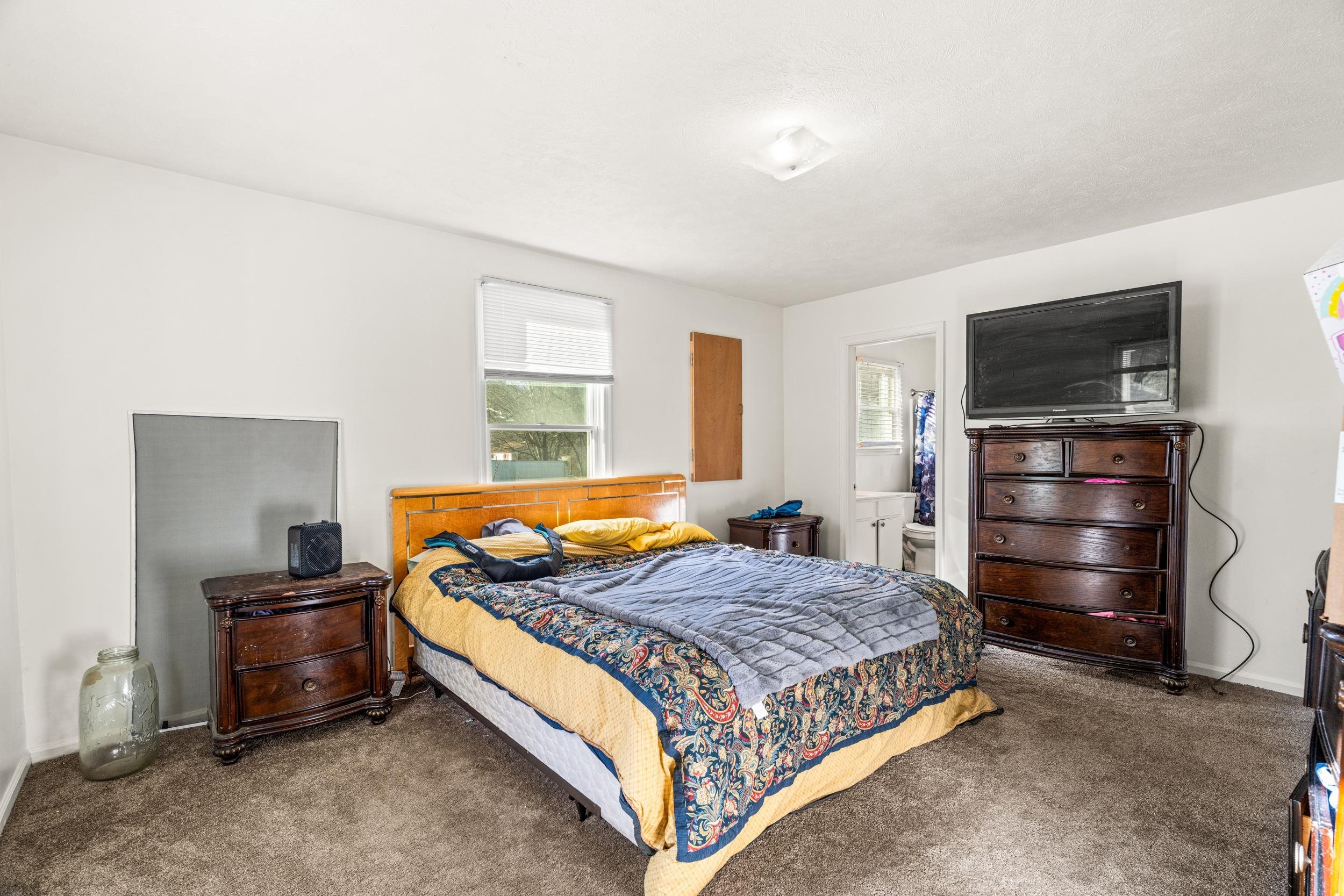 1316 East Main Street Waynesboro, VA 22980 - Photo 25 of 34 a bedroom with a bed and a flat screen tv