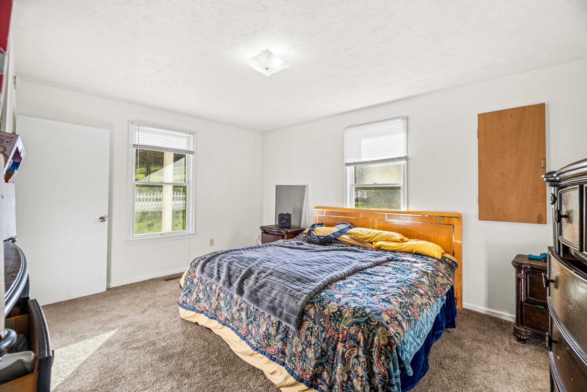 1316 East Main Street Waynesboro, VA 22980 - Photo 26 of 34 a bedroom with a bed and a window