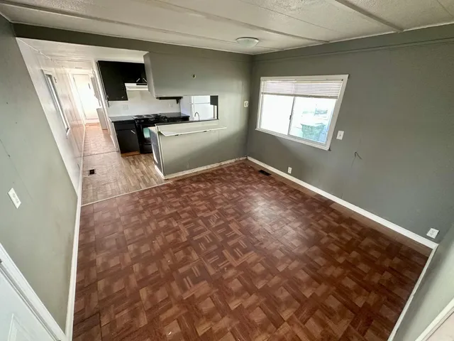 a view of kitchen with sink microwave and cabinets