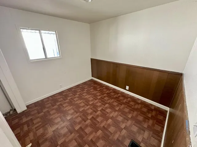 an empty room with wooden floor