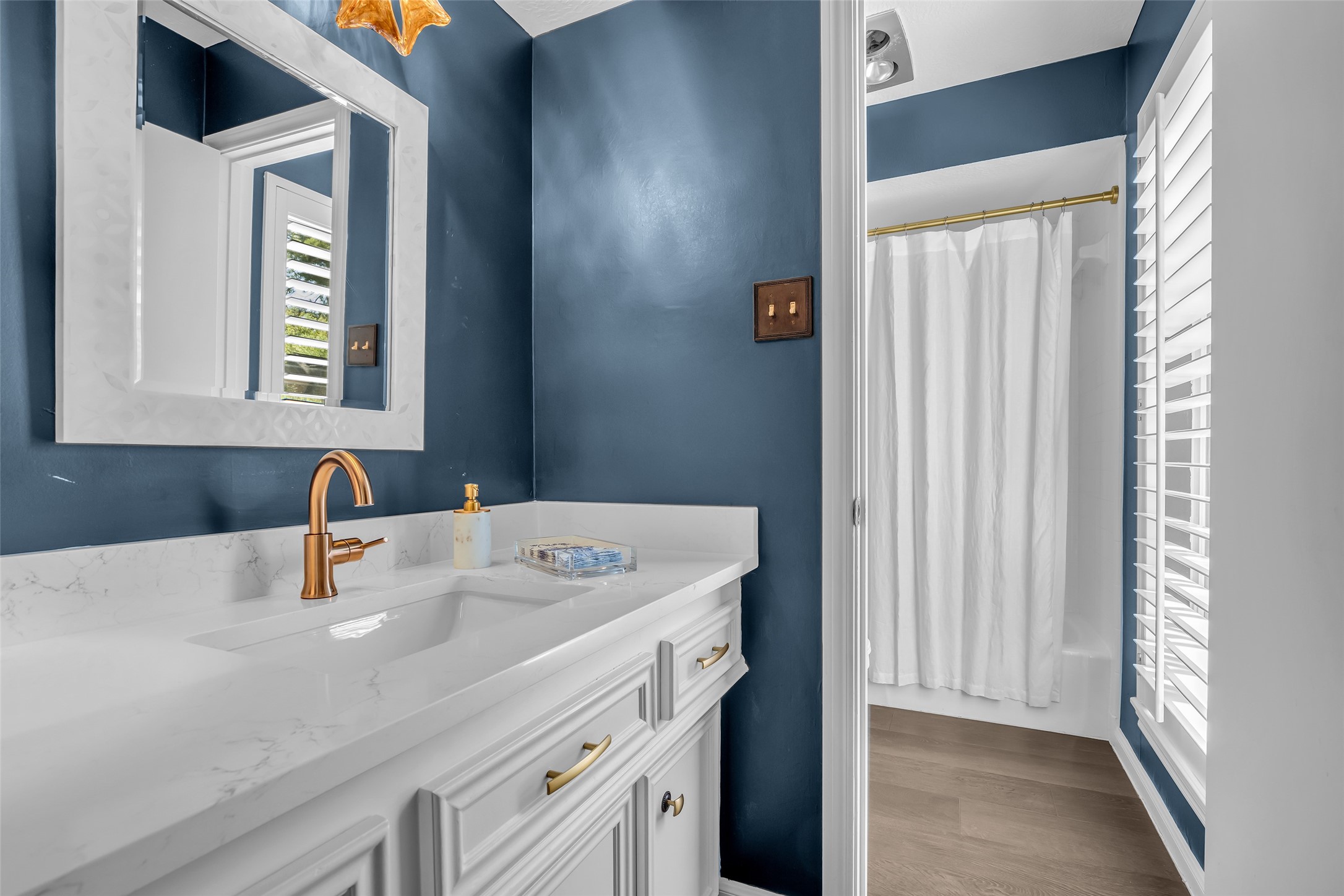 9318 Appin Falls Drive Spring, TX 77379 - Photo 23 of 35 a bathroom with a sink a mirror and a window