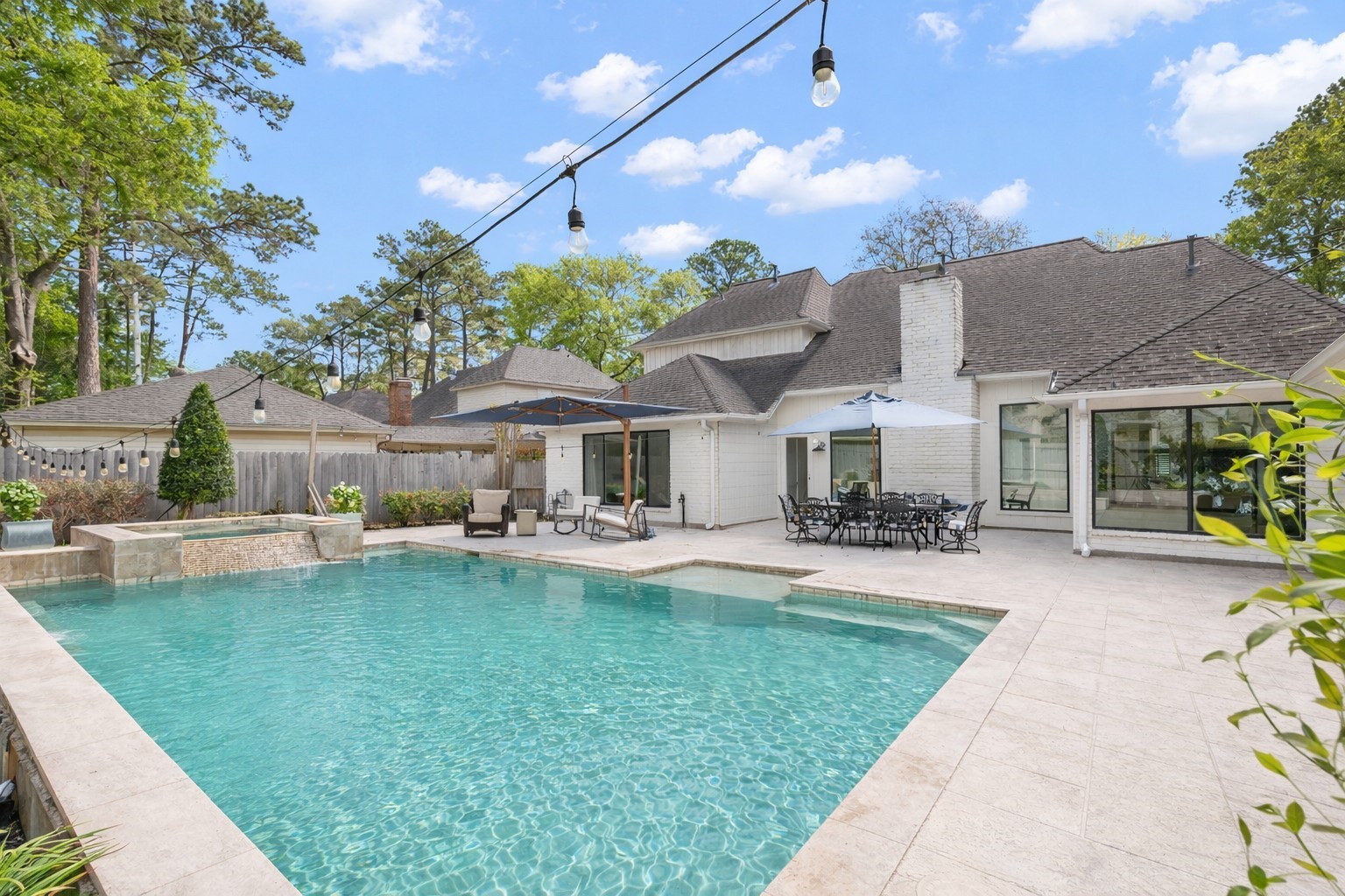 9318 Appin Falls Drive Spring, TX 77379 - Photo 30 of 35 a front view of a house with swimming pool having outdoor seating