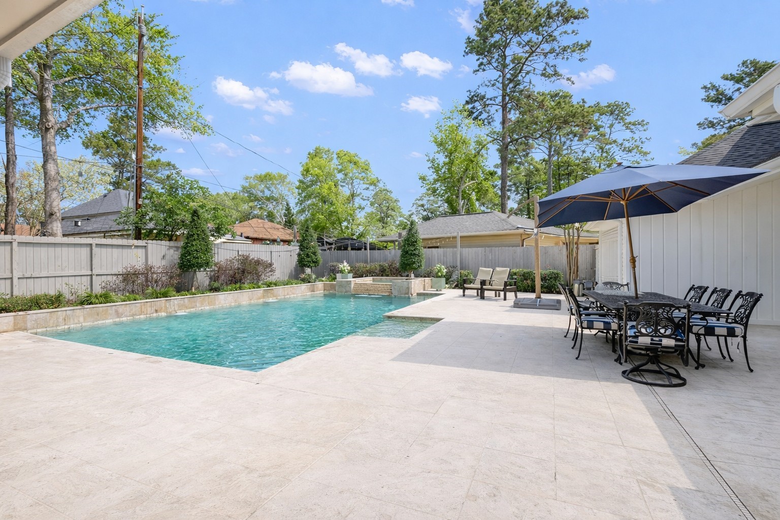 9318 Appin Falls Drive Spring, TX 77379 - Photo 31 of 35 a view of a patio with a table and chairs under an umbrella