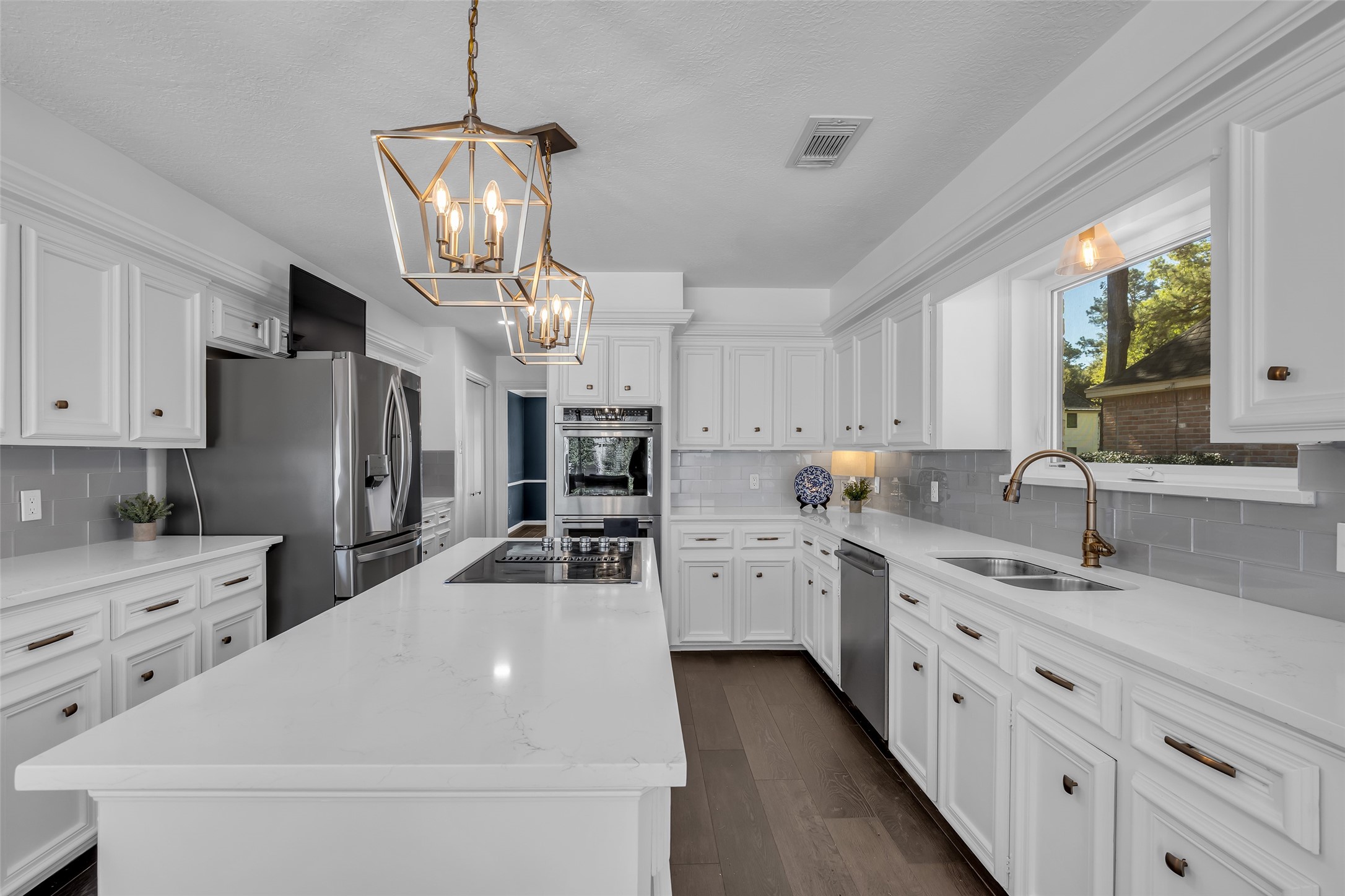 9318 Appin Falls Drive Spring, TX 77379 - Photo 7 of 35 a kitchen with stainless steel appliances a refrigerator sink and cabinets