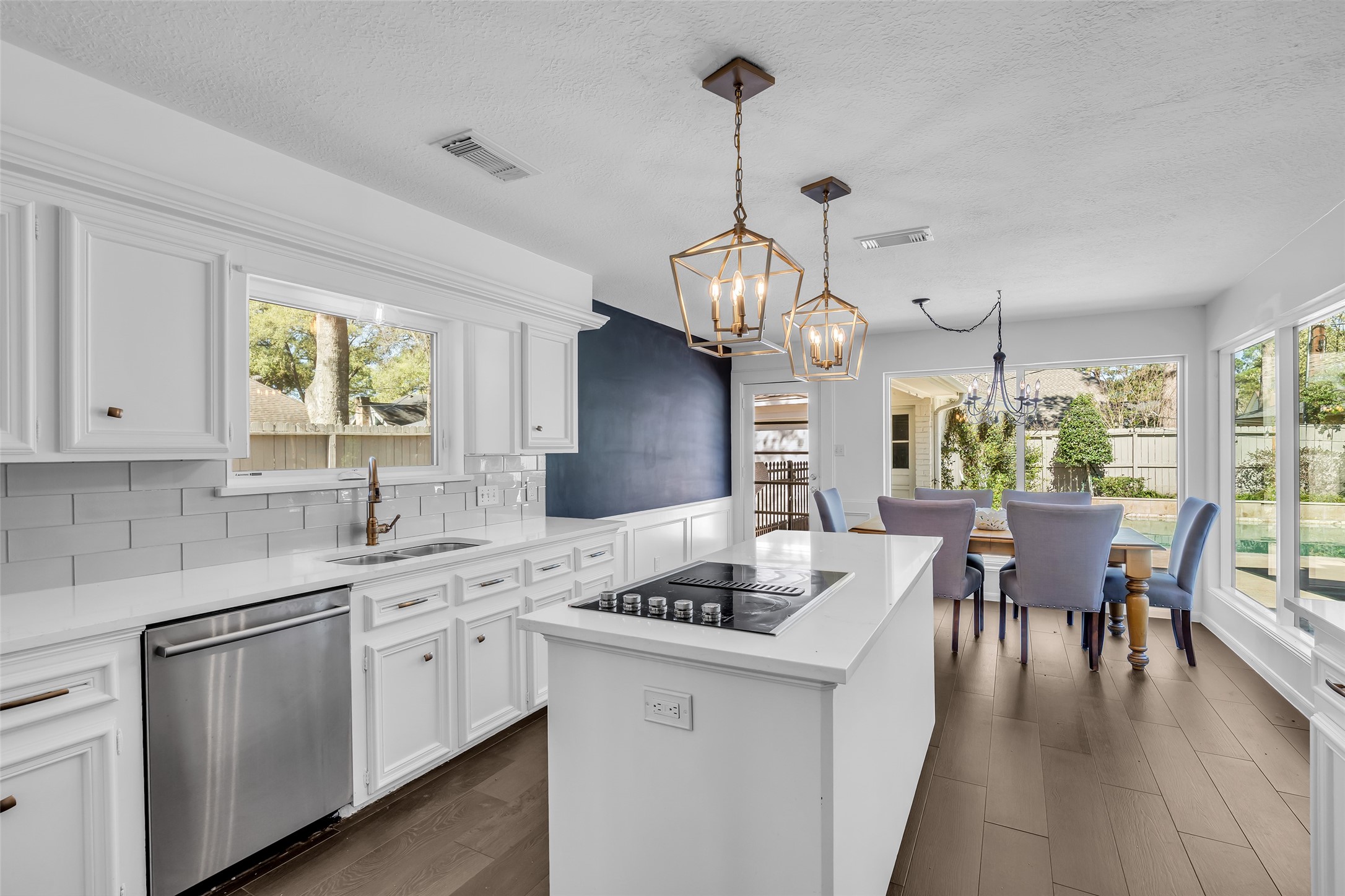 9318 Appin Falls Drive Spring, TX 77379 - Photo 9 of 35 a open kitchen with stainless steel appliances granite countertop a stove top oven a sink dishwasher a dining table and chairs with wooden floor