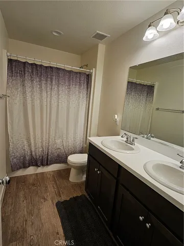 a bathroom with a double vanity sink and a mirror