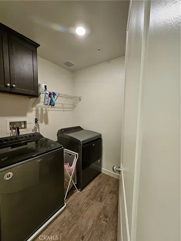 a kitchen with a refrigerator and a stove top oven
