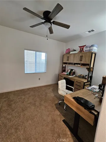 a room with furniture and a ceiling fan