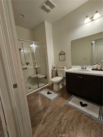 a bathroom with a double vanity sink toilet and shower