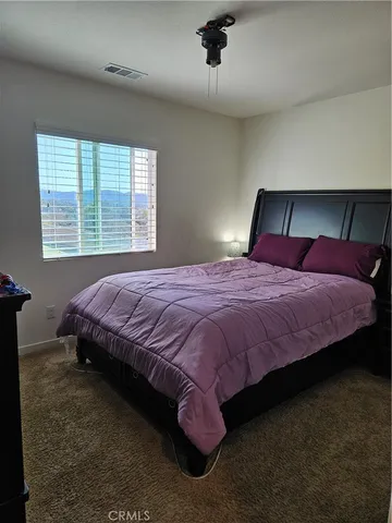 a bedroom with a bed and window