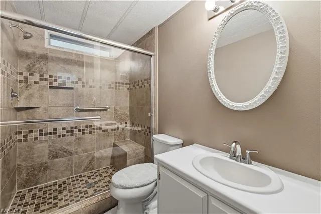 a bathroom with a sink toilet and shower