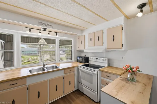 a kitchen that has a sink and a stove