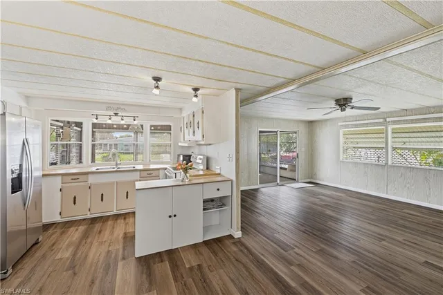 a kitchen with stainless steel appliances granite countertop a stove and a wooden floors