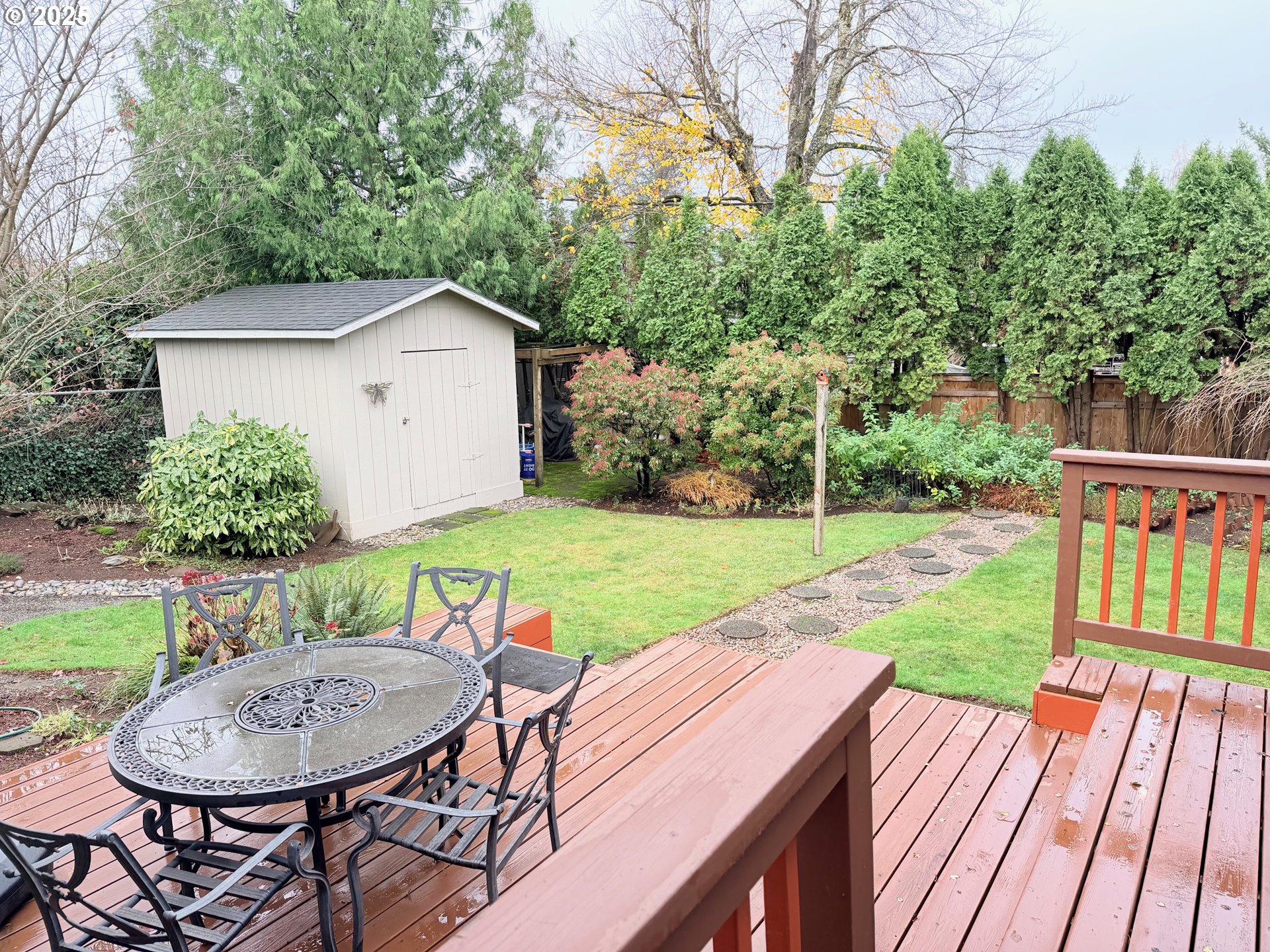 114 Maple Boulevard Wood Village, OR 97060 - Photo 17 of 23 a view of a wooden dinning table and chairs in backyard of the house