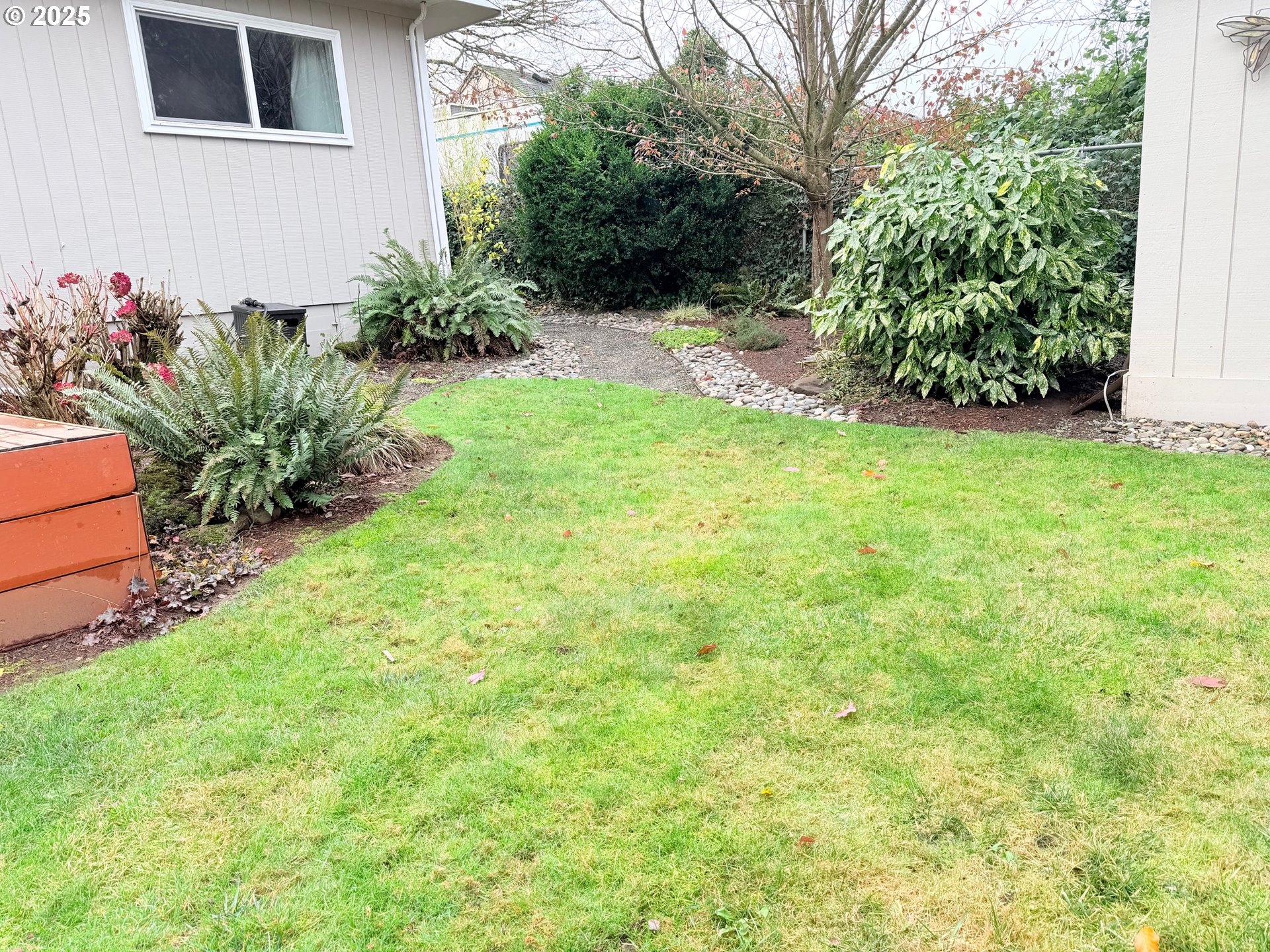 114 Maple Boulevard Wood Village, OR 97060 - Photo 22 of 23 a view of a back yard with flower plants
