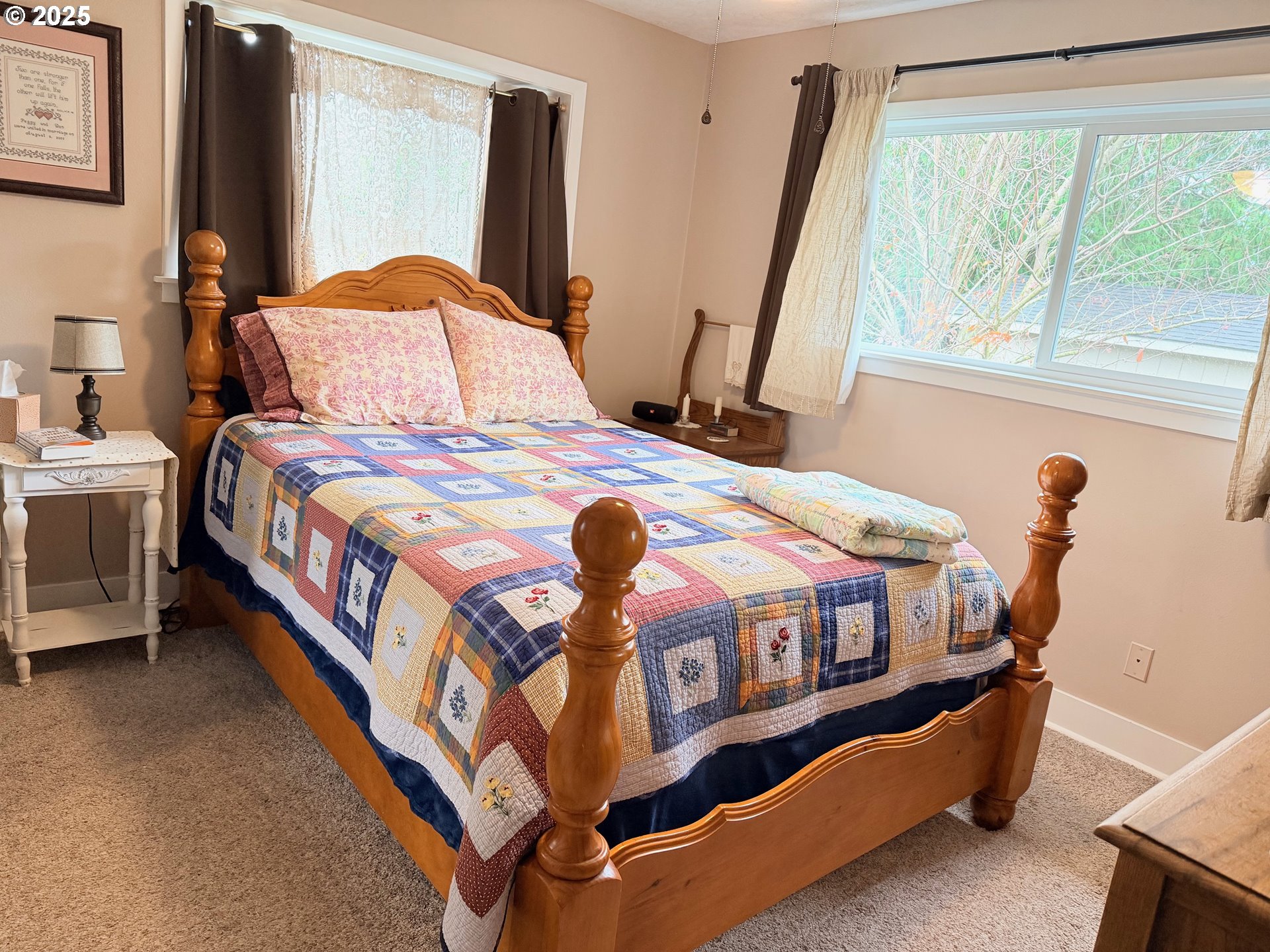 114 Maple Boulevard Wood Village, OR 97060 - Photo 4 of 23 a bedroom with a bed next to a large window