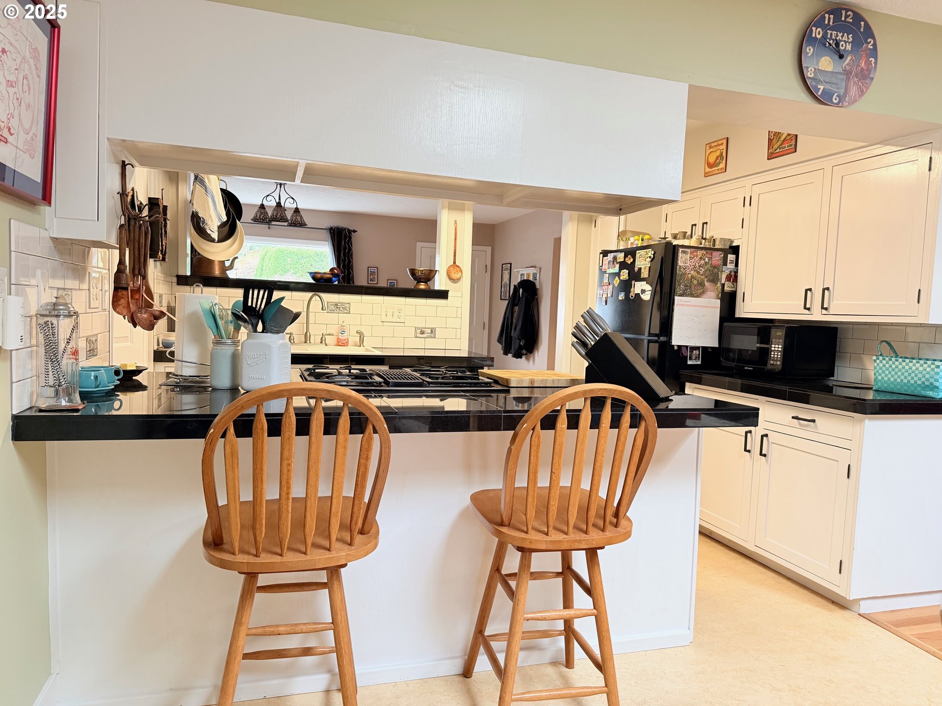 114 Maple Boulevard Wood Village, OR 97060 - Photo 7 of 23 a view of a kitchen with stainless steel appliances wooden floor dining table and chairs