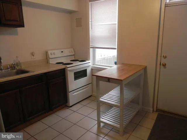 a kitchen with a sink cabinets and a window