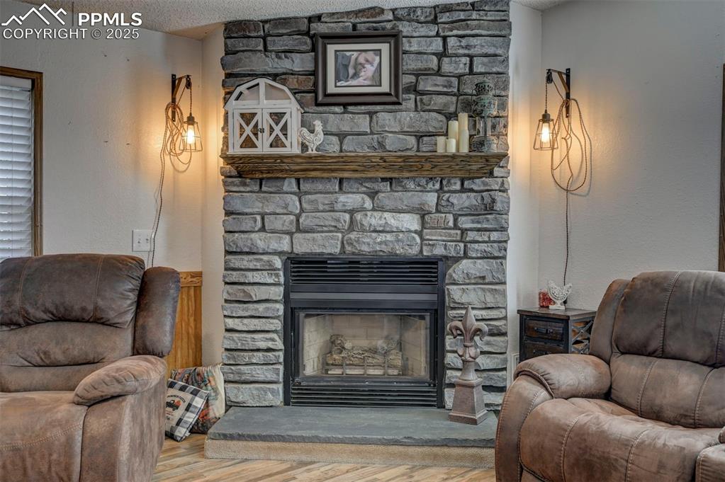 35355 Funk Road Calhan, CO 80808 - Photo 17 of 31 a living room with furniture a fireplace and a chandelier