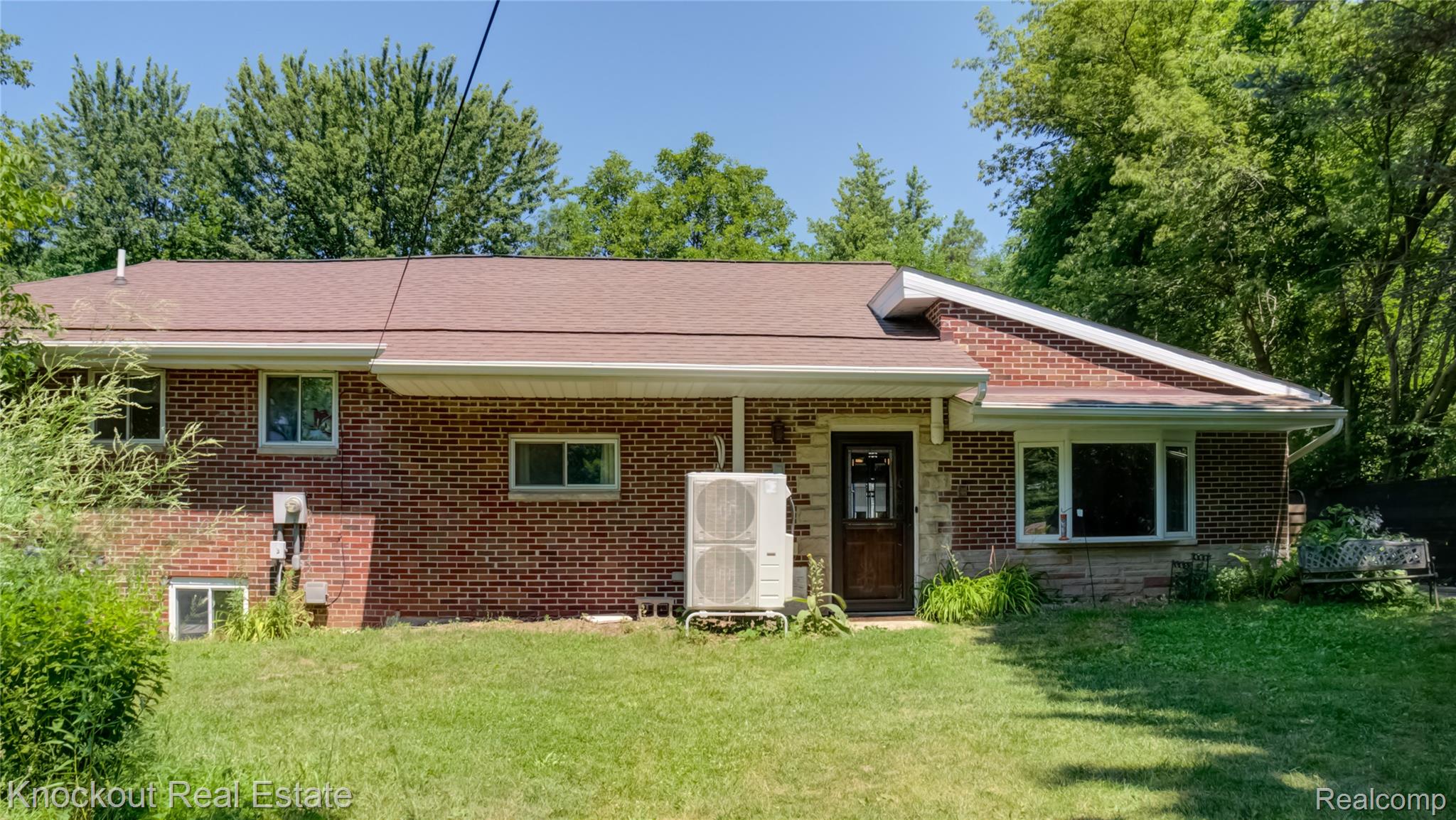 4195 Williamson Road Saginaw, MI 48601 - Photo 2 of 50 Brick exterior with stone accents, brown shingle roof, and multiple windows providing natural light