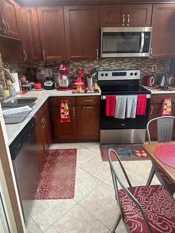 a kitchen with a sink cabinets and a window