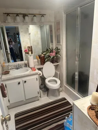 a bathroom with a toilet and a shower