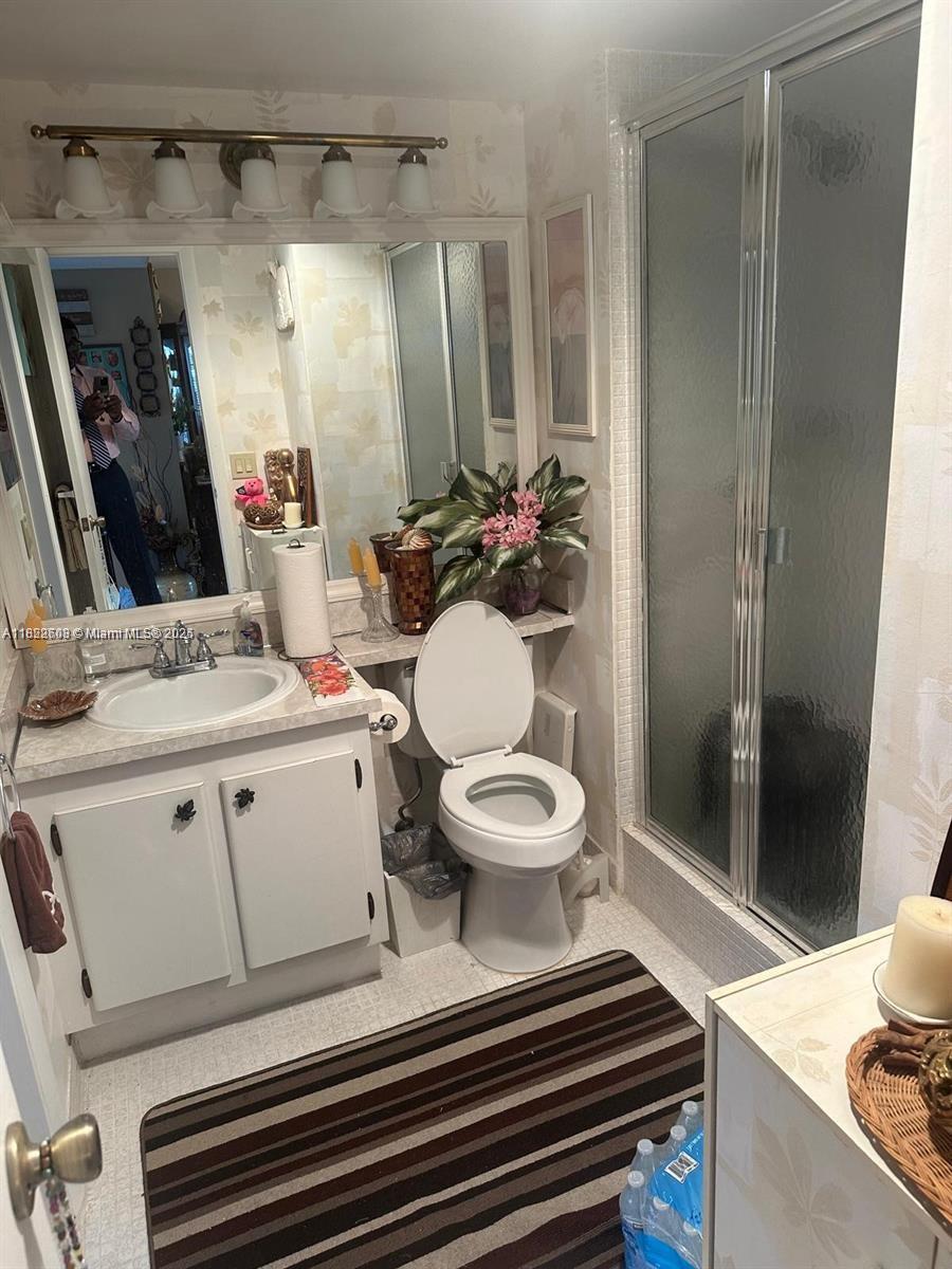 8834 West McNab Road, Unit 302 Tamarac, FL 33321 - Photo 14 of 25 a bathroom with a sink toilet and shower