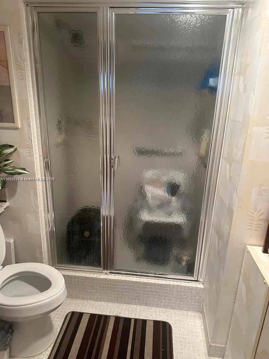 8834 West McNab Road, Unit 302 Tamarac, FL 33321 - Photo 15 of 25 a bathroom with a toilet and a shower