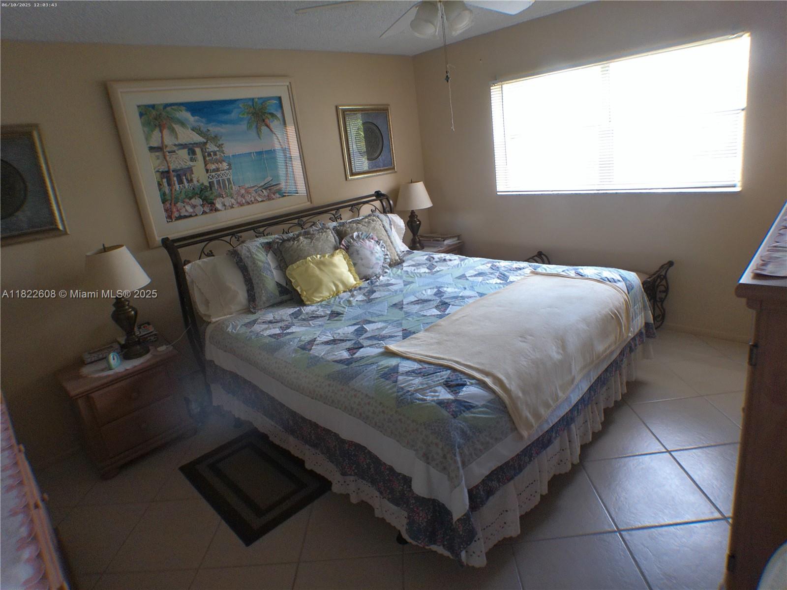 8834 West McNab Road, Unit 302 Tamarac, FL 33321 - Photo 16 of 25 a bedroom with a bed and window