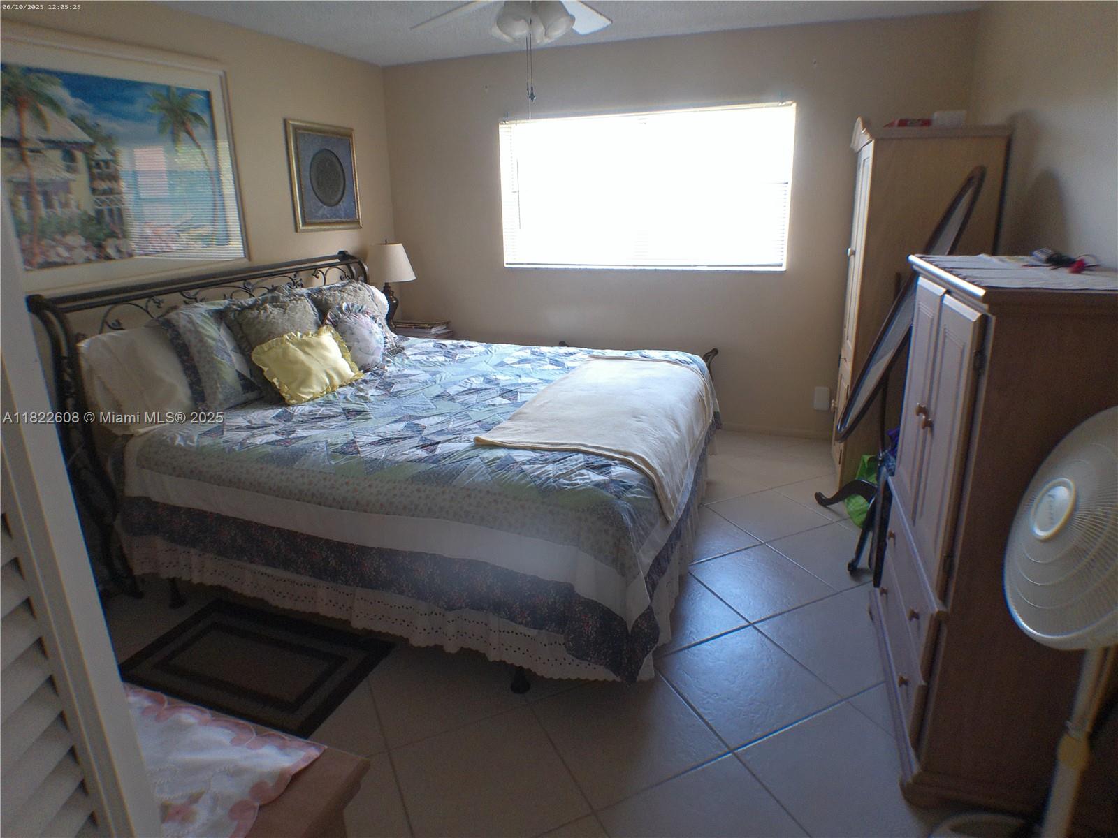 8834 West McNab Road, Unit 302 Tamarac, FL 33321 - Photo 18 of 25 a bed sitting in a bedroom next to a window