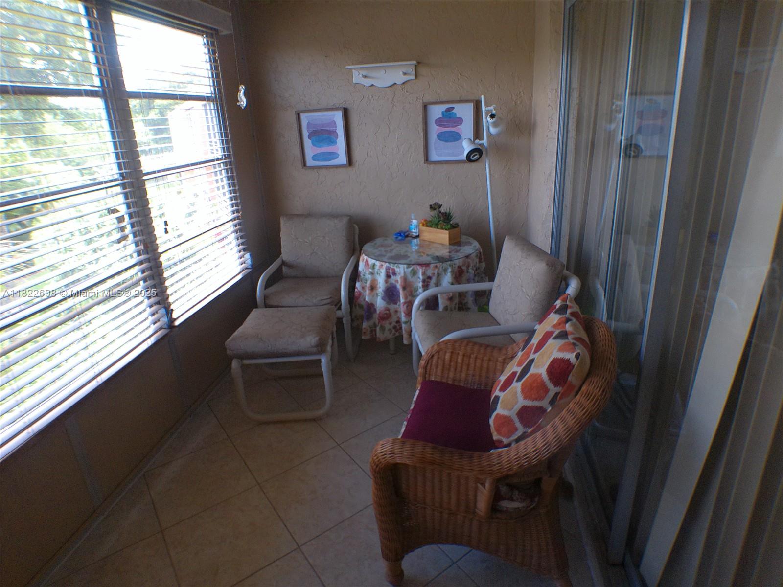 8834 West McNab Road, Unit 302 Tamarac, FL 33321 - Photo 23 of 25 a living room with furniture and a window