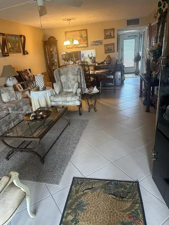 a living room with furniture and a painting on the wall