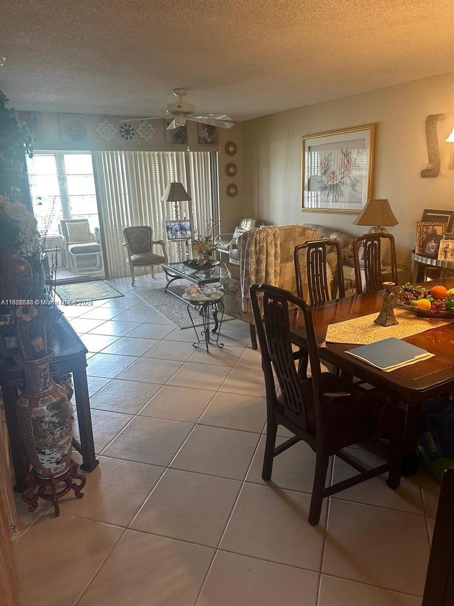 8834 West McNab Road, Unit 302 Tamarac, FL 33321 - Photo 9 of 25 a view of a dining room with furniture