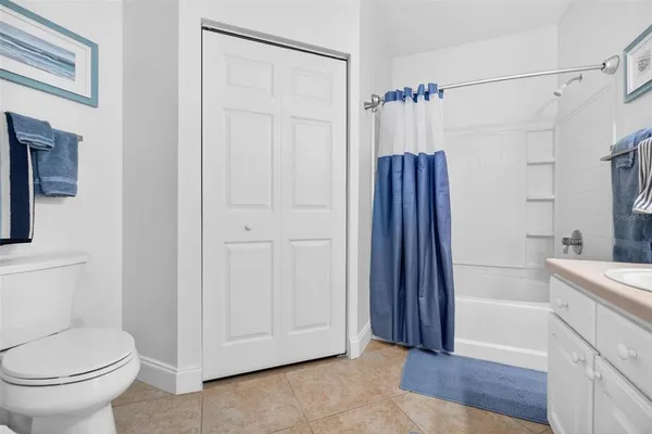 a bathroom with a shower a toilet and sink