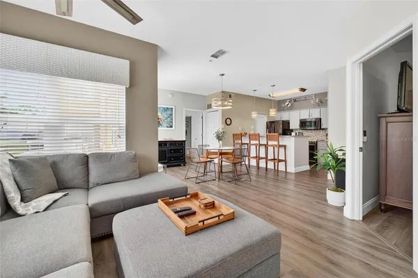 a living room with furniture and wooden floor