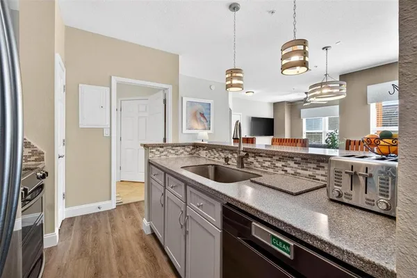 a kitchen with a stove a sink and a refrigerator