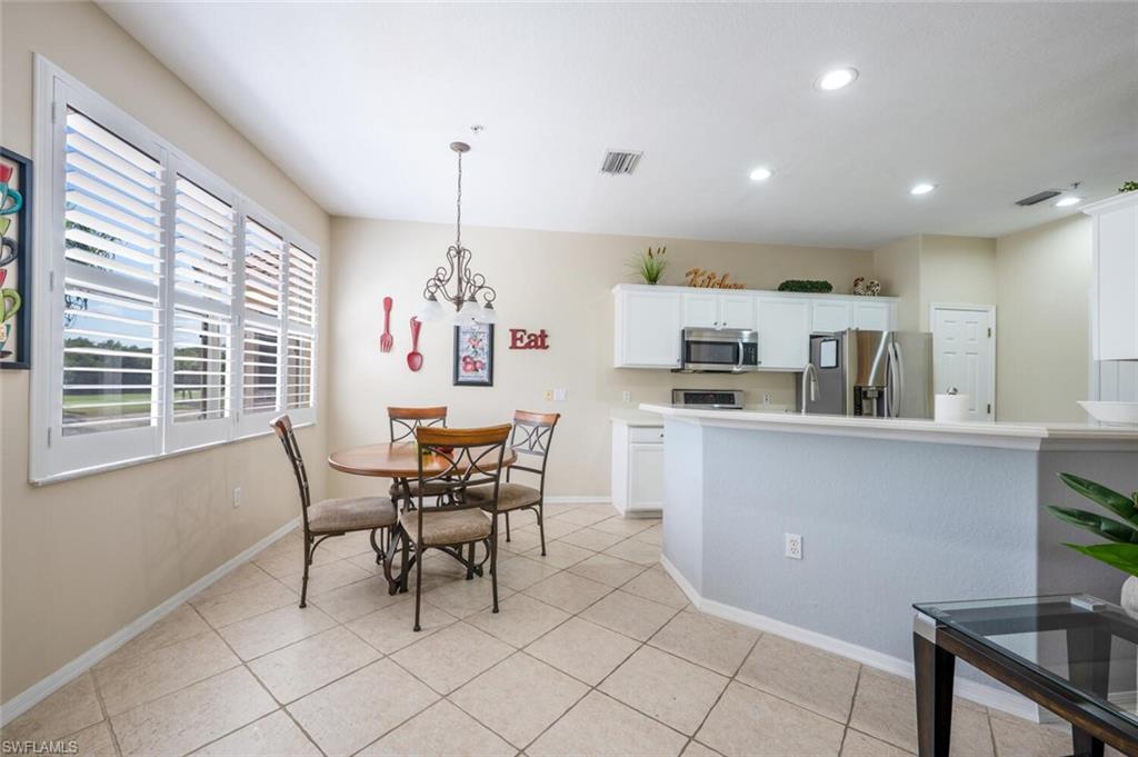 4630 Winged Foot Court, Unit 202 Naples, FL 34112 - Photo 12 of 32 Dining space with recessed lighting, light tile patterned floors, baseboards, visible vents, and a notable chandelier