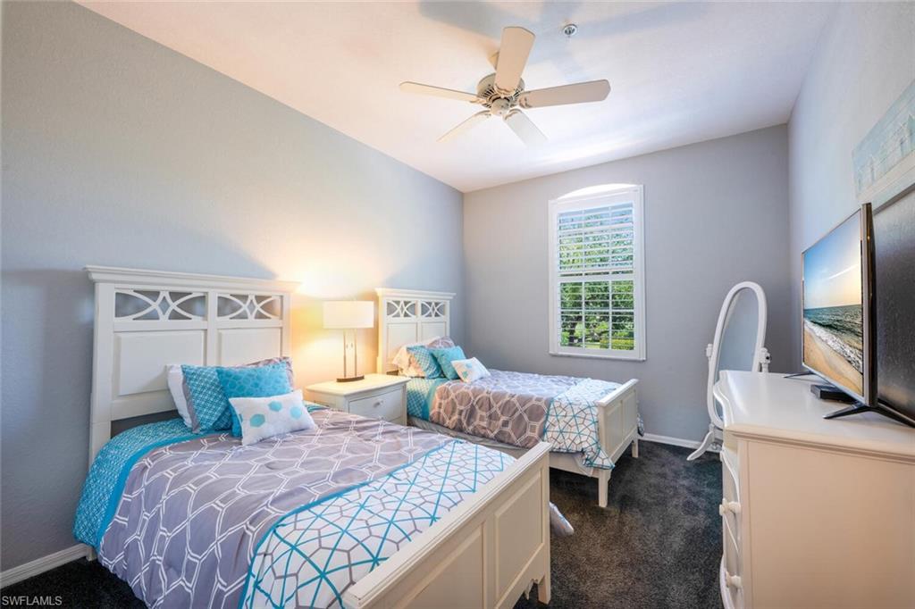 4630 Winged Foot Court, Unit 202 Naples, FL 34112 - Photo 16 of 32 Bedroom featuring dark colored carpet, ceiling fan, and baseboards
