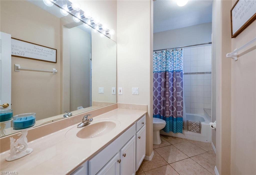 4630 Winged Foot Court, Unit 202 Naples, FL 34112 - Photo 17 of 32 Full bath featuring toilet, vanity, shower / bath combination with curtain, and tile patterned floors