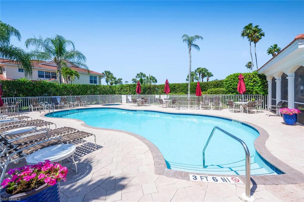 4630 Winged Foot Court, Unit 202 Naples, FL 34112 - Photo 25 of 32 Community pool featuring a patio area and fence